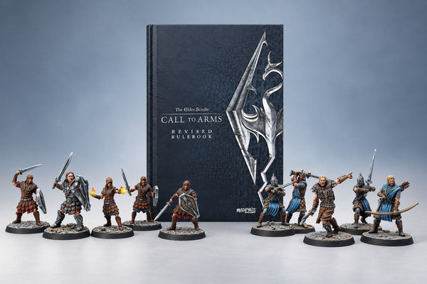 The Elder Scrolls: Call to Arms Revised Rulebook between Imperial Legion and Stormcloak miniatures on a grey blue studio backdrop