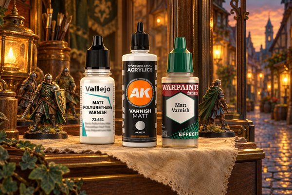 Matt varnish bottles from Vallejo, AK and The Army Painter on a shop window shelf in a lantern lit Chapmen town street